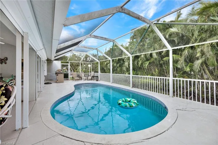 View of swimming pool with a lanai and a patio