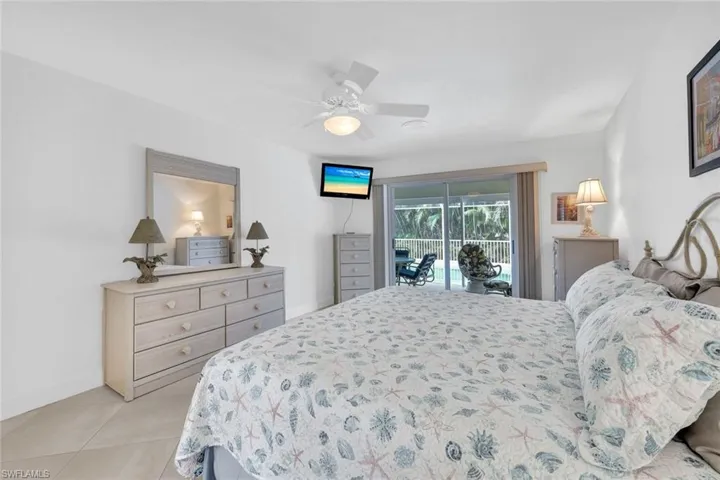 Bedroom featuring access to exterior, ceiling fan, and light tile patterned flooring