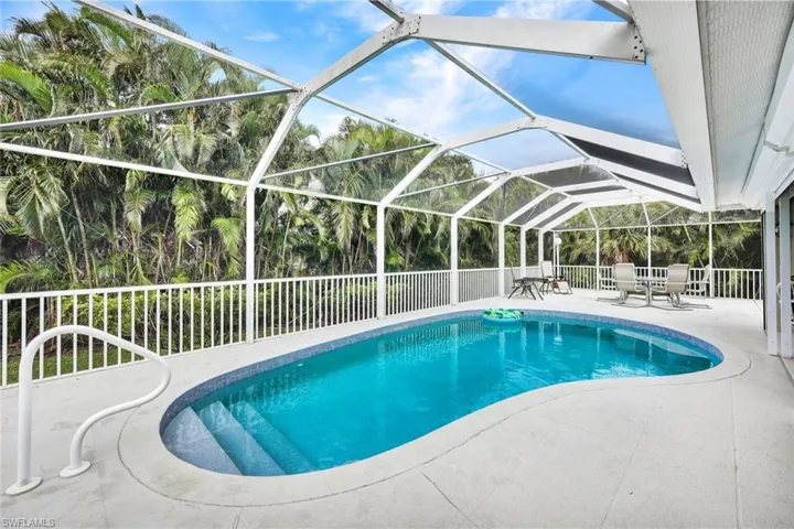 View of swimming pool featuring a lanai and a patio area