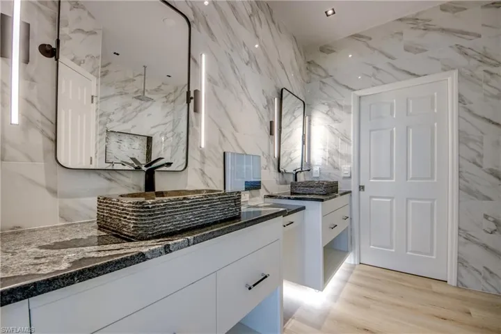 Bathroom with tile walls and vanity