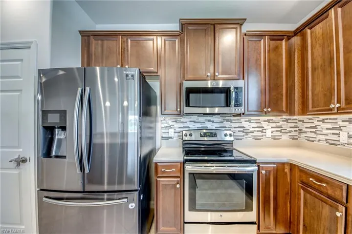 Kitchen featuring tasteful backsplash and stainless steel appliances