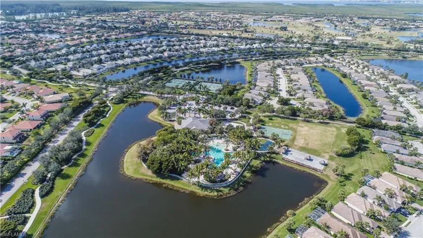 Birds eye view of property with a water view