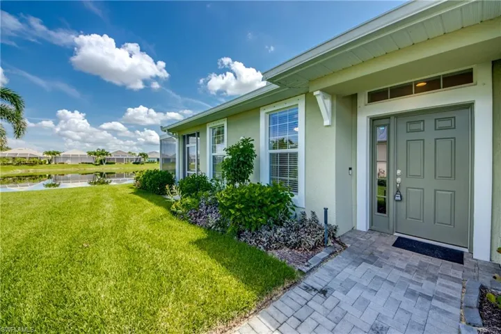 Doorway to property featuring a yard