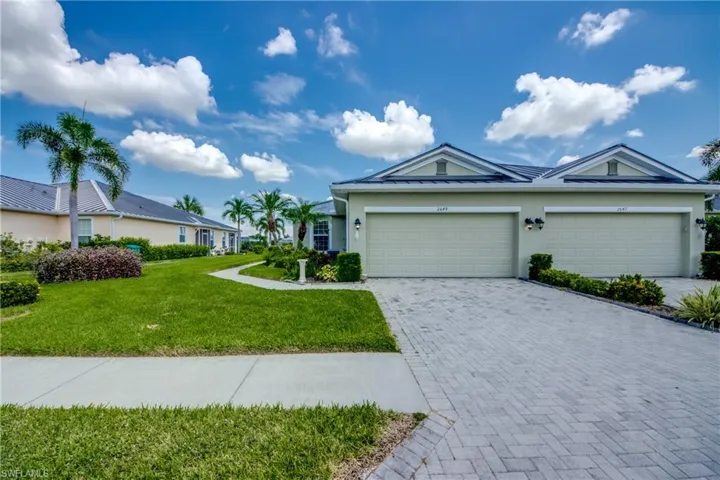 Ranch-style home with a front lawn and a garage