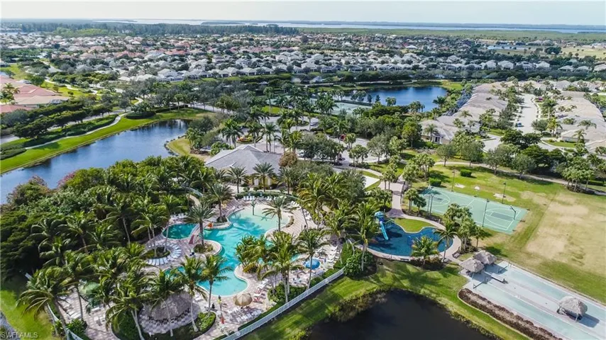 Birds eye view of property with a water view