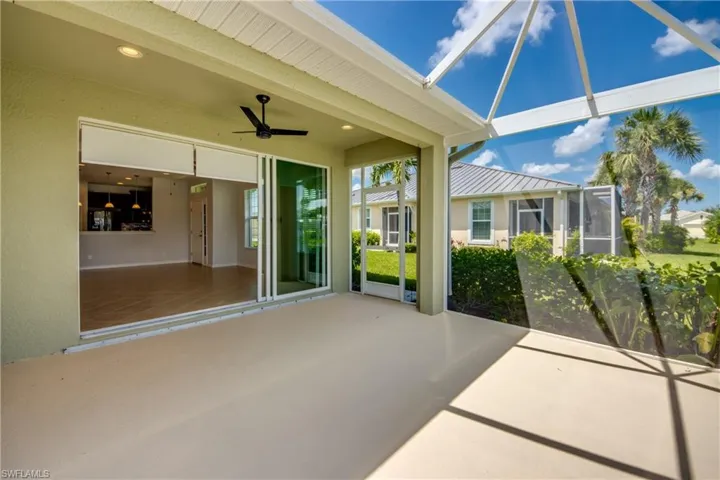 Unfurnished sunroom featuring ceiling fan
