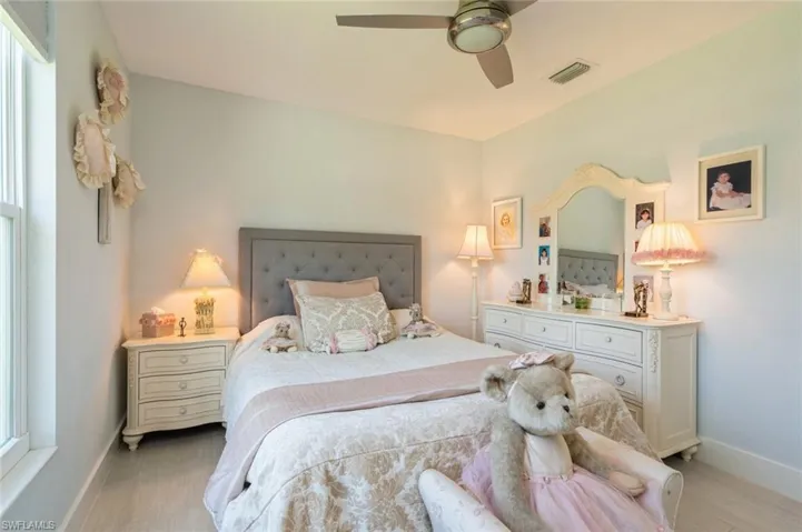 Bedroom with a ceiling fan and multiple windows