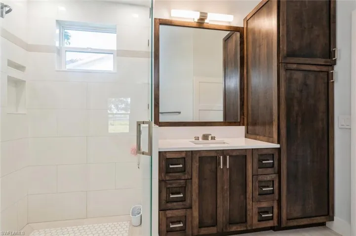 Bathroom featuring vanity and a shower stall