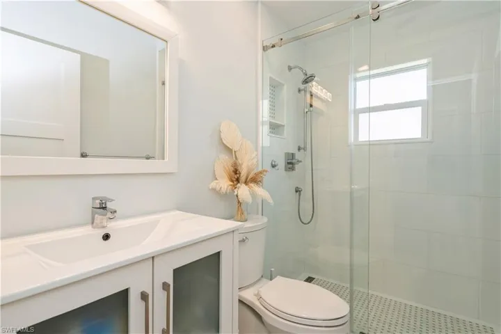 Bathroom featuring vanity and a shower stall