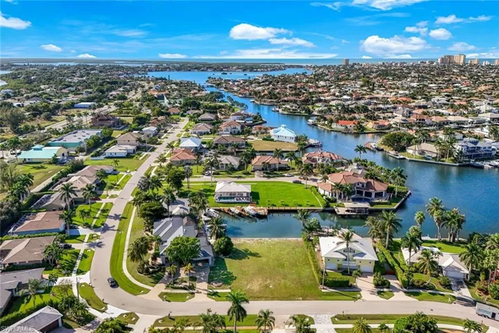 Aerial perspective of suburban area featuring a large body of water