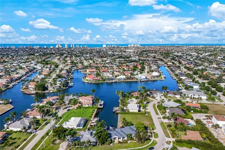 Aerial perspective of suburban area featuring a nearby body of water