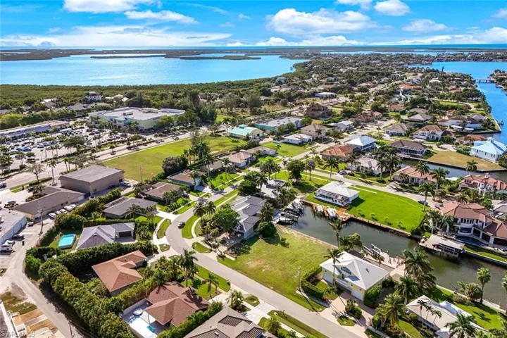 Aerial perspective of suburban area with a nearby body of water
