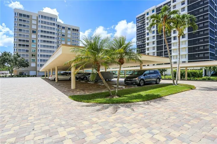 View of apartment building / complex with covered parking