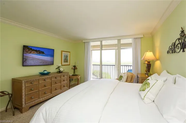 Carpeted bedroom featuring access to outside and crown molding