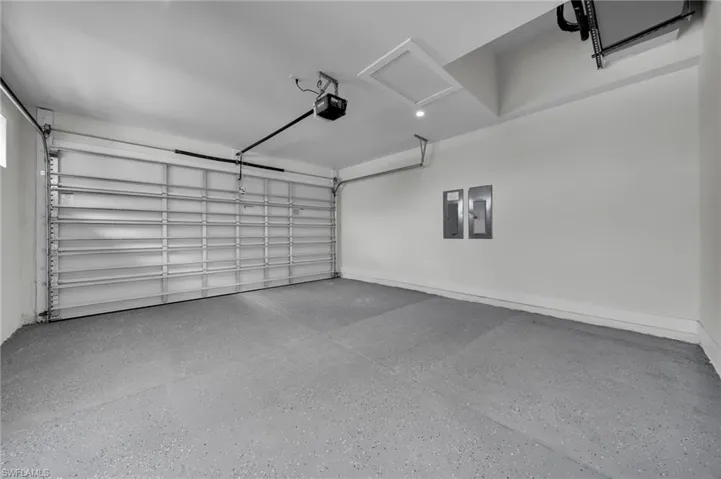 Garage with a garage door opener and electric panel