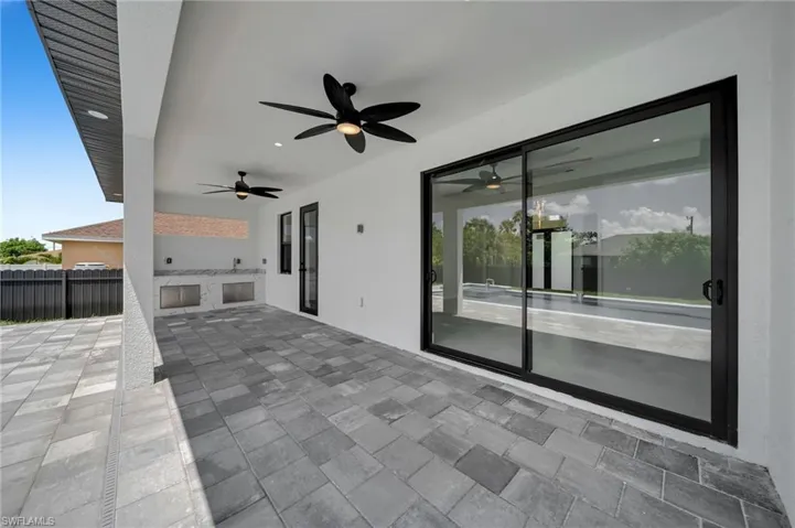 View of patio / terrace with ceiling fan and area for grilling