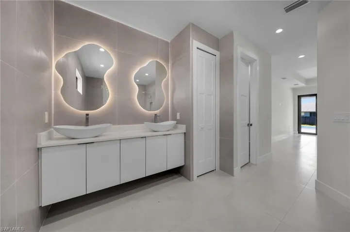 Full bath featuring double vanity and recessed lighting