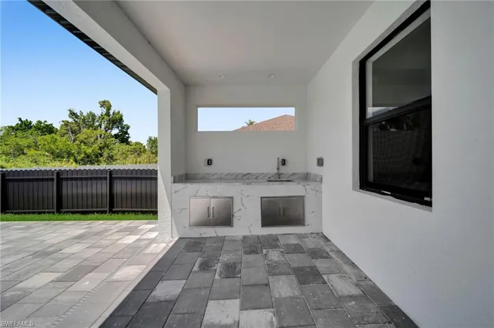 View of patio / terrace featuring an outdoor kitchen and a sink