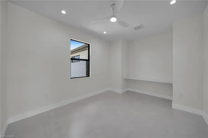 Empty room with finished concrete floors, recessed lighting, and a ceiling fan