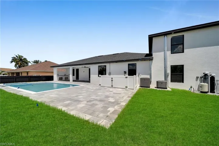 Back of house with stucco siding and a patio