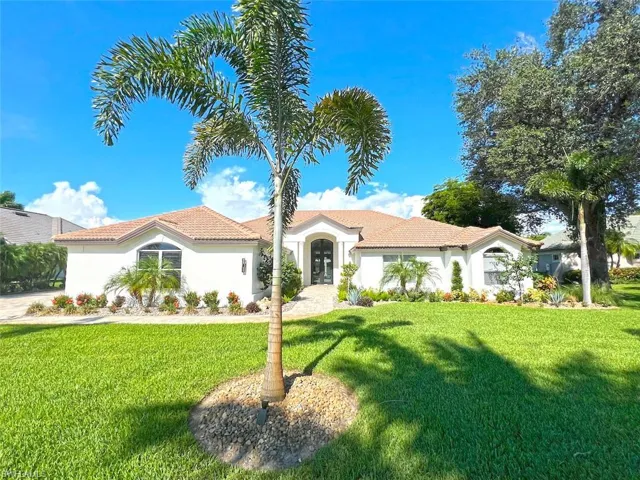 Mediterranean / spanish home with a front lawn