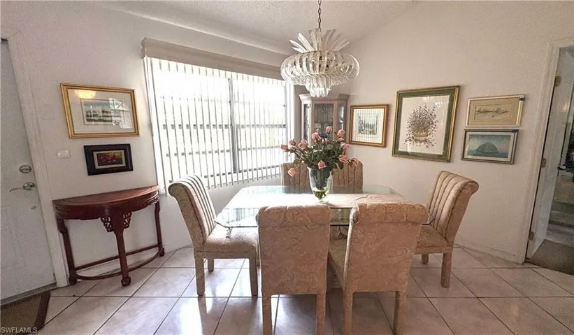 Cheerful entryway to the Dining area of this 2nd-floor condo featuring tile flooring & cathedral ceiling!
