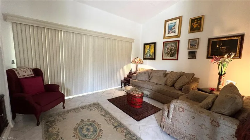 The spacious Living room features lofted ceiling and sliding doors to the screened balcony.