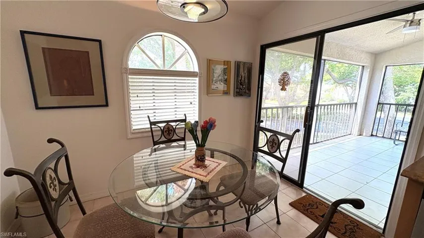 Eat-in Kitchen has a lovely water view from the spacious screened balcony, light patterned tile floor, and vaulted ceiling.