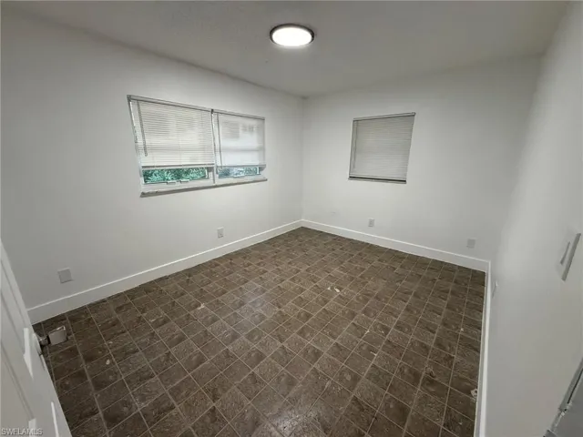 Unfurnished room with baseboards