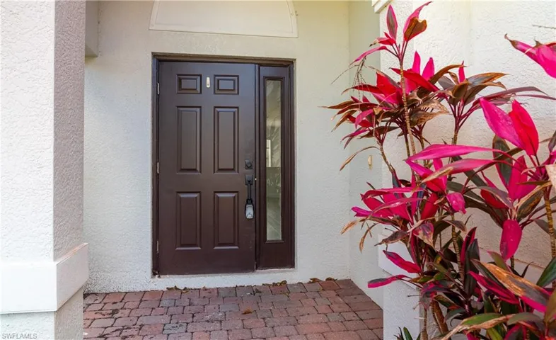 View of exterior entry featuring stucco siding