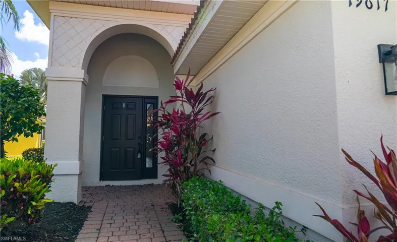 Entrance to property with stucco siding