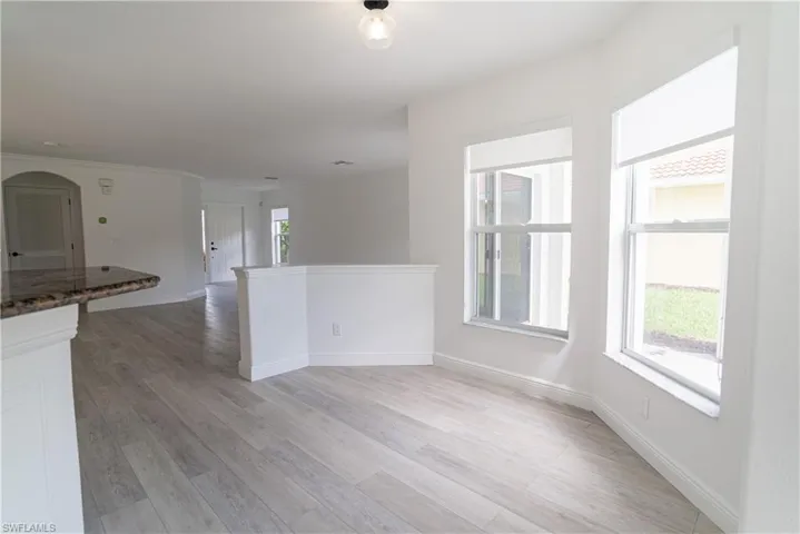 Unfurnished room with light wood finished floors and baseboards