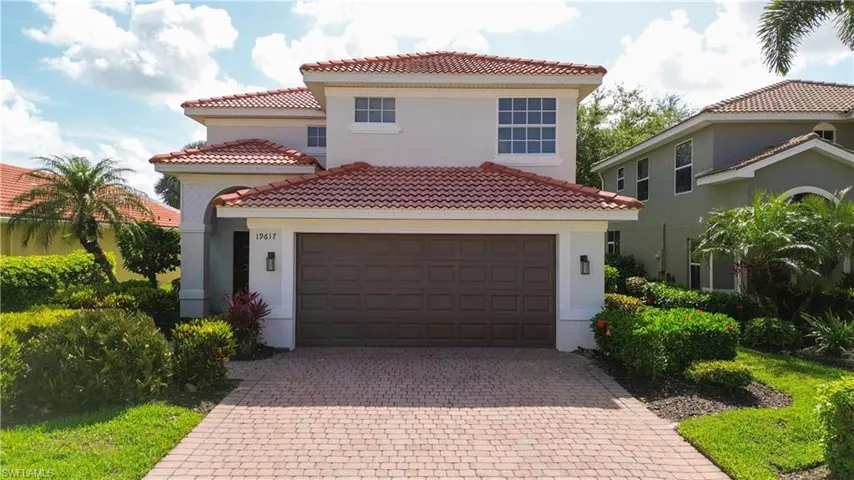 Mediterranean / spanish-style home with decorative driveway, a tiled roof, stucco siding, and a garage