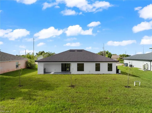 Rear view of property featuring a patio and a yard