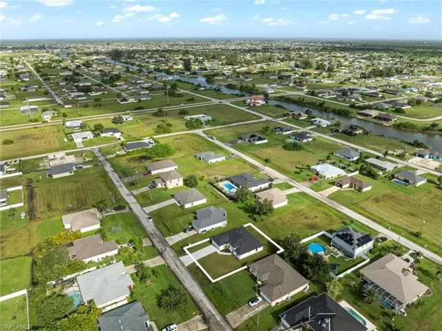Birds eye view of property with a water view