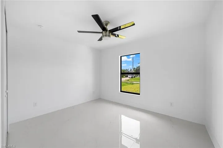 Unfurnished room with tile patterned flooring and ceiling fan