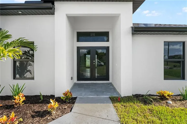 Property entrance featuring french doors
