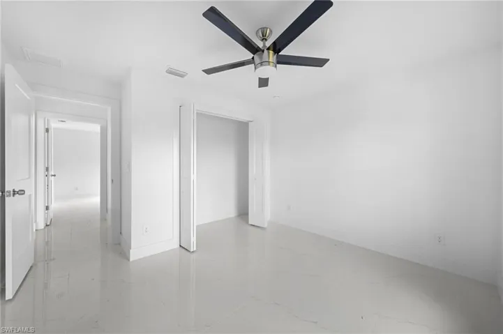 Spare room featuring light tile patterned floors and ceiling fan