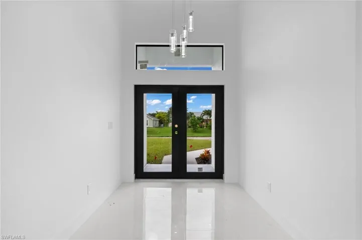 Doorway to outside with tile patterned flooring and french doors