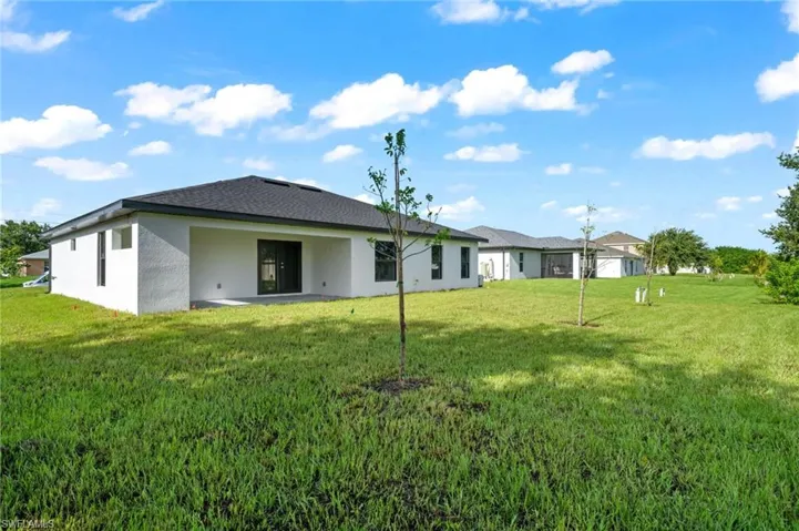 Rear view of house featuring a yard