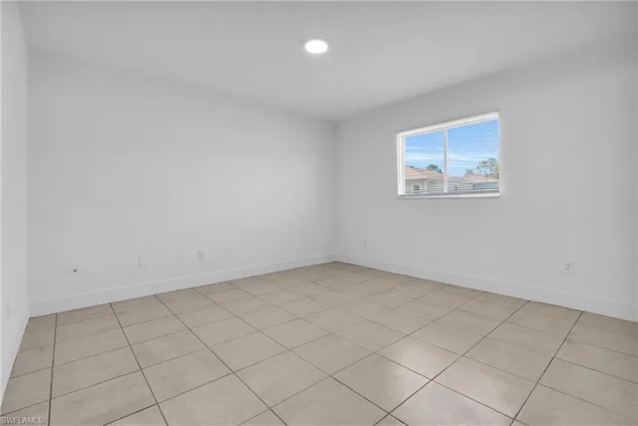 Empty room with light tile patterned floors