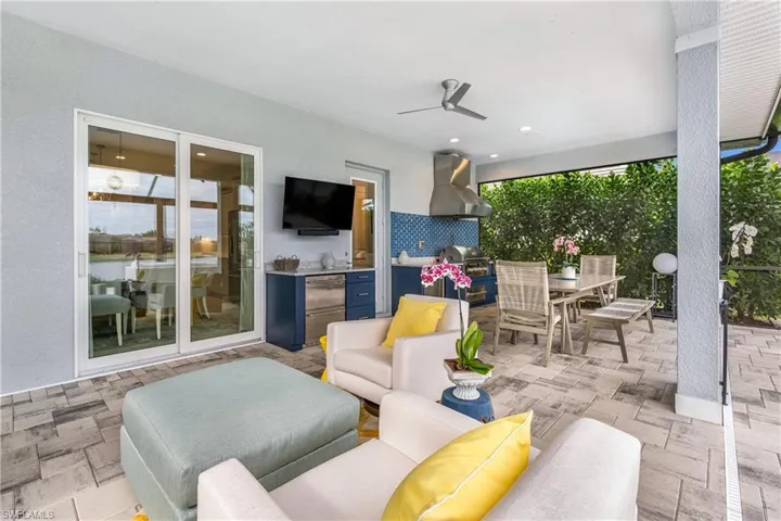 View of patio with ceiling fan, an outdoor hangout area, exterior kitchen, and area for grilling