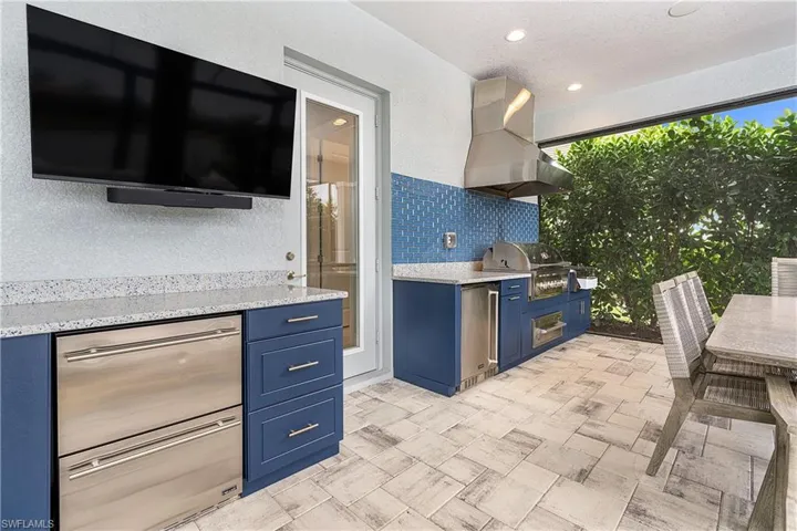 View of patio featuring a grill and an outdoor kitchen