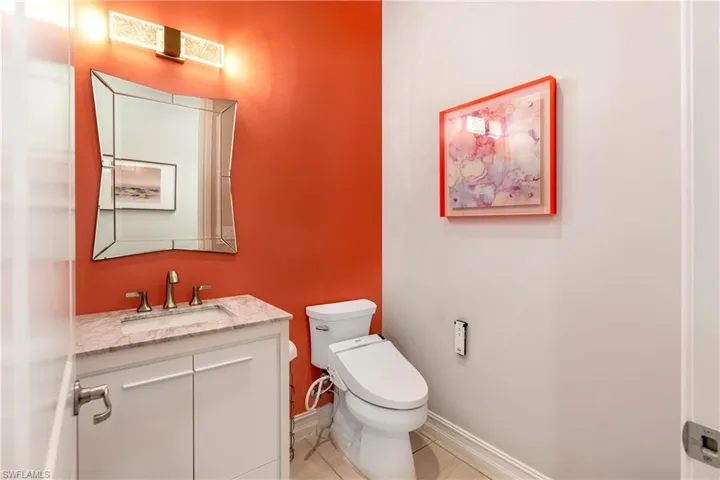 Bathroom featuring toilet, tile patterned floors, and vanity