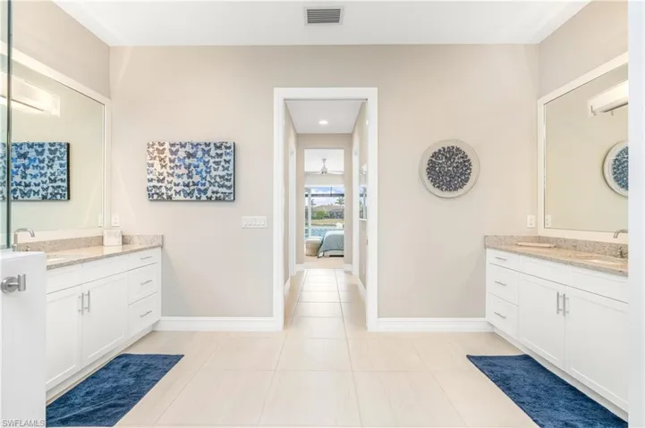 Bathroom featuring ceiling fan, tile patterned floors, and vanity