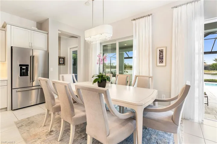 Dining space with light tile patterned flooring