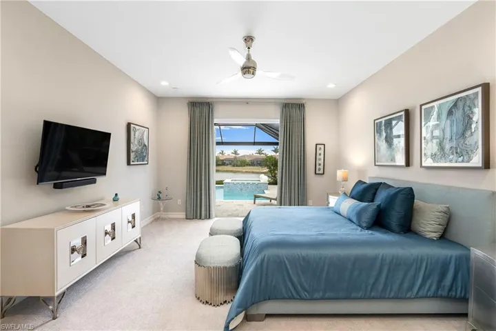 Bedroom featuring light carpet and ceiling fan