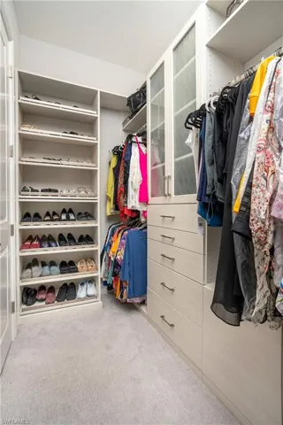 Walk in closet featuring carpet flooring