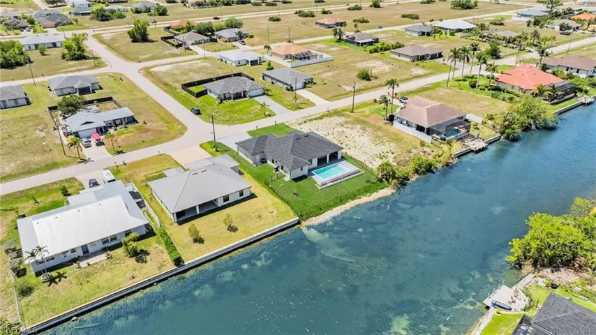 Birds eye view of property featuring a water view and a residential view