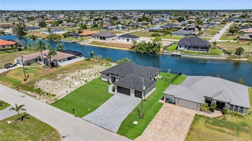 Birds eye view of property featuring a residential view and a water view